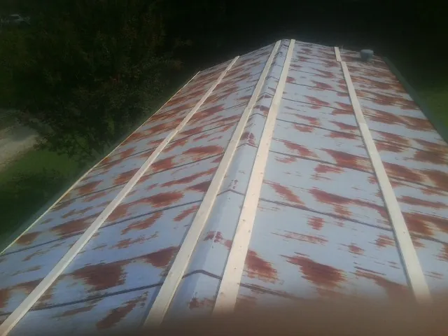 Rusted metal roof panels with new wood purlins before replacement — Storm Damage Roof Repair in Bronwood by Roofing Brothers