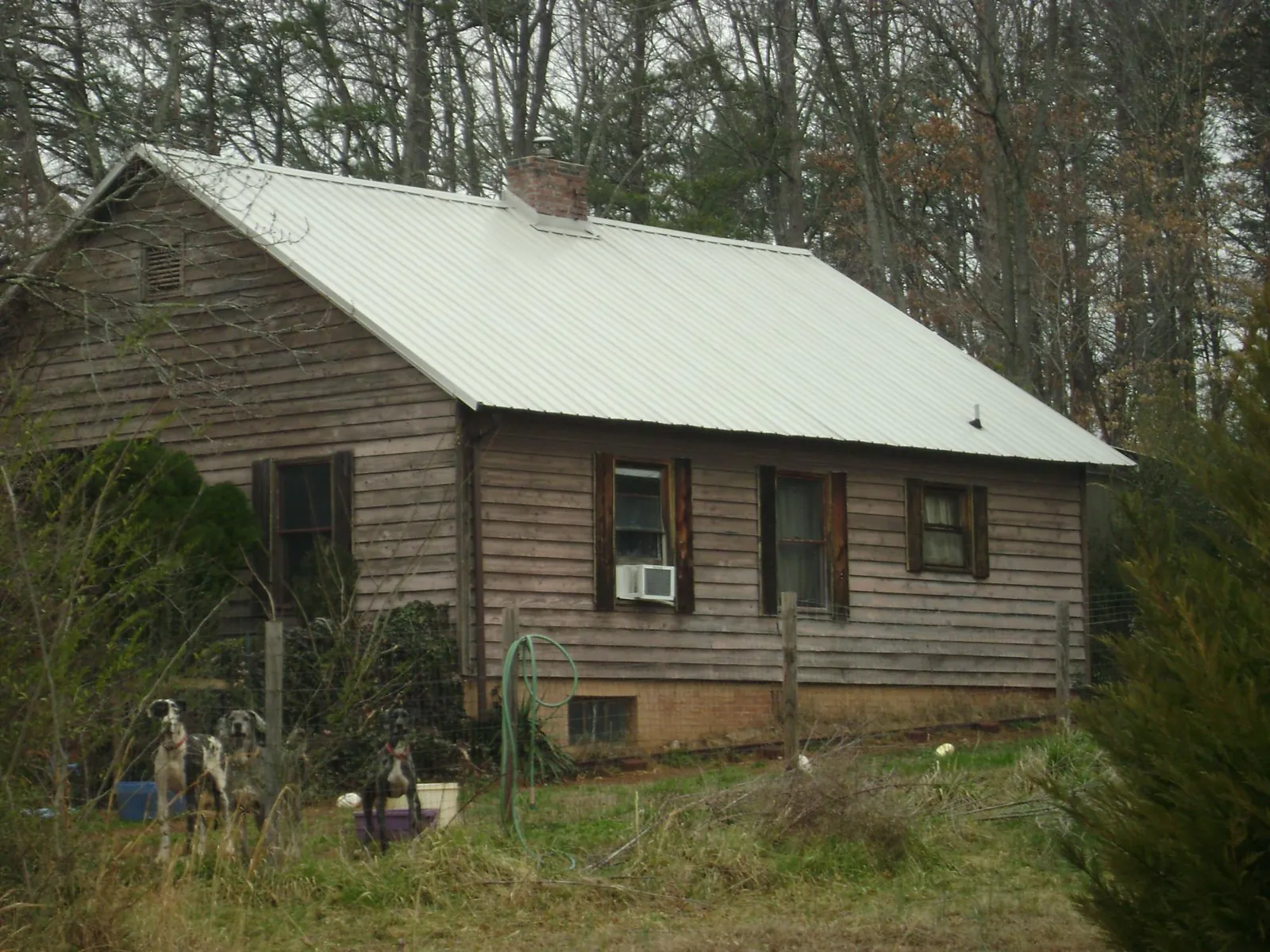 White metal roof on an old wood sided farmhouse, from a Metal Roof Installation job in Bronwood